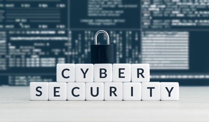 Cyber security words on blocks, closed padlock and computer data